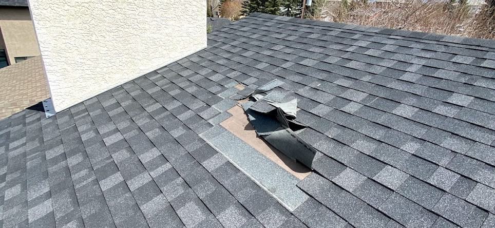 Shingles coming off of a improperly installed roof in Calgary.,
