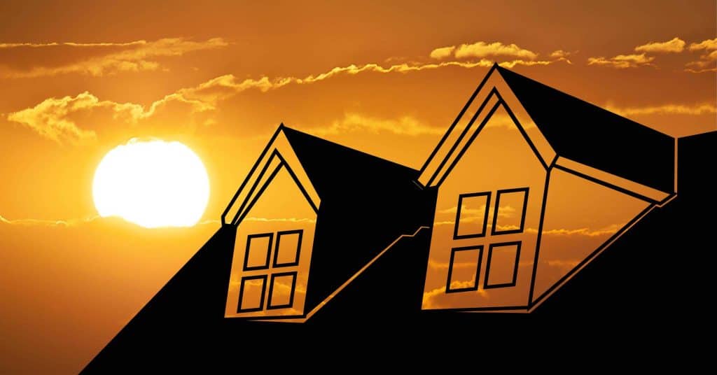 Hot summer sky with a silhouette of a roof