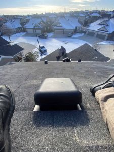 Roofs in Calgary During Winter while working on a roofing insulation and ventilation.