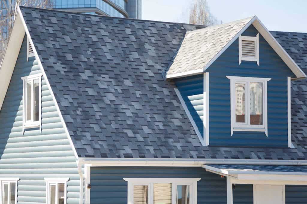 Blue and White Suburban Home. Painting, highlighting the color of shingles