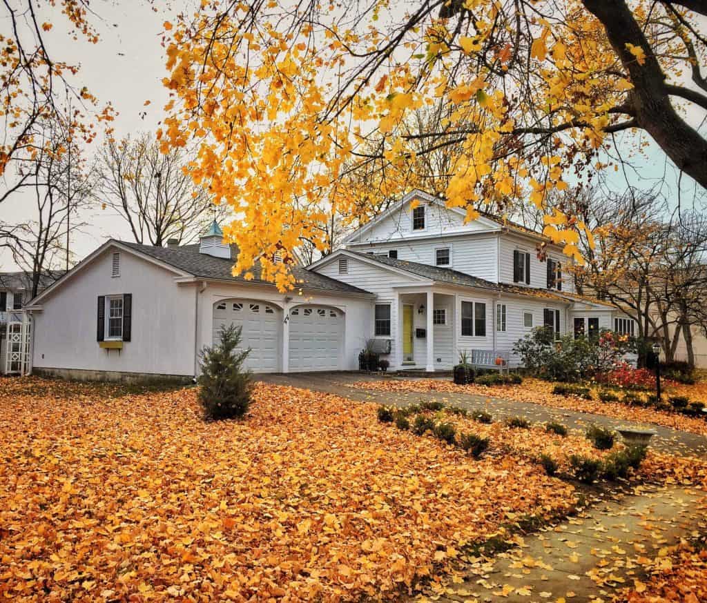 A modern home in the fall that needs a roof inspection