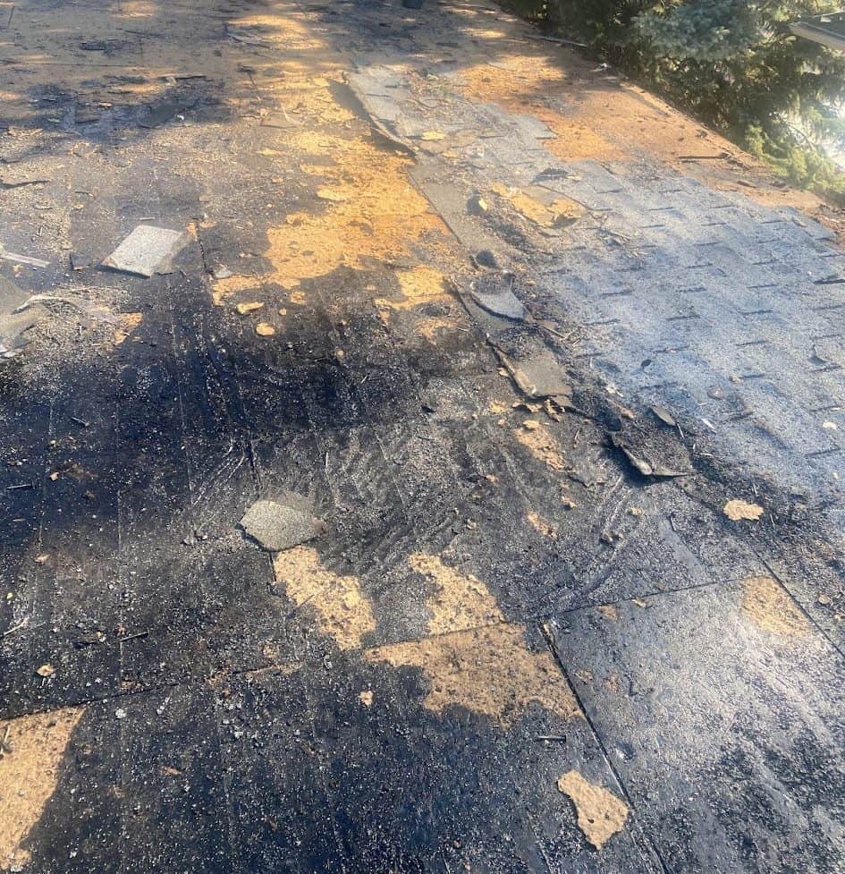 A torn off roof showing decking and roofing layers