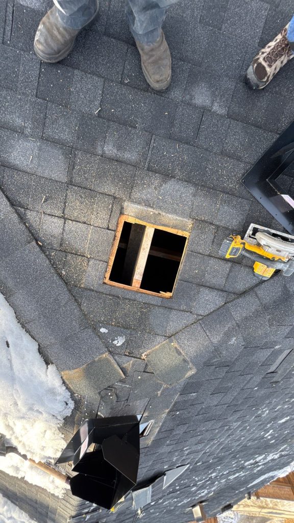 A vent hole being enlarged to help ventilate a roof better