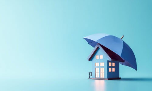 Blue house model under an umbrella symbolizing home insurance and roof protection in Alberta