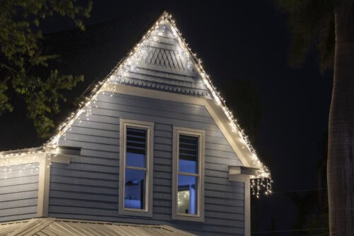 Brightly illuminated christmas decorations on front yard of florida family home. Outside decor for winter holidays.