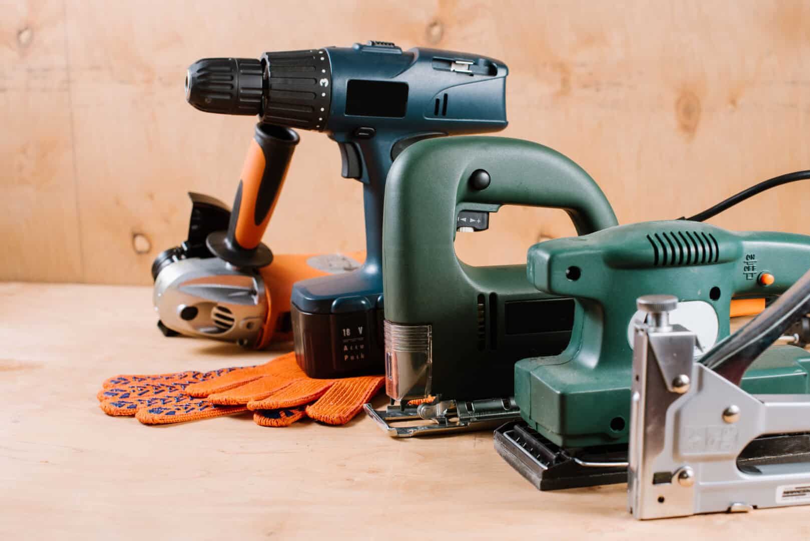 Electric building and crafting instruments and tools on the wooden background